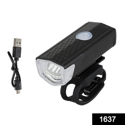 Bright front bike light illuminating a dark path.