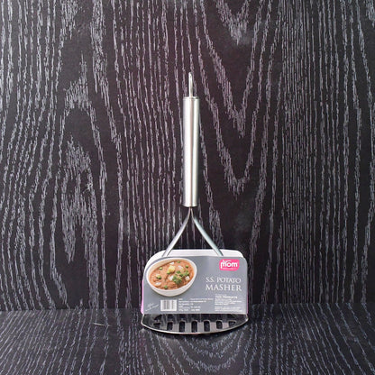 Potato masher in kitchen environment with ergonomic handle