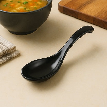 Black plastic soup spoon with curved ergonomic handle for comfortable grip