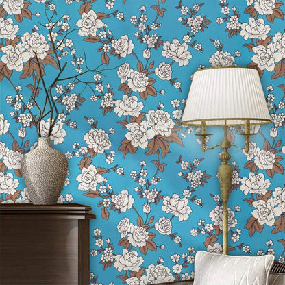 Applied floral wallpaper roll on wall showcasing vibrant pattern