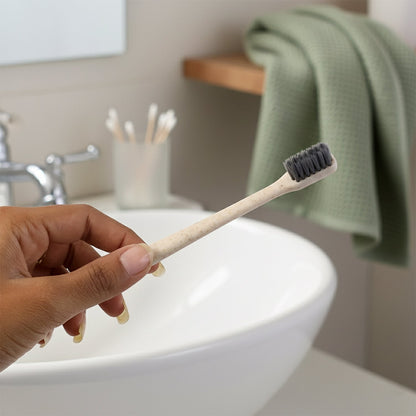 The MintGuard Soft-bristle Toothbrush resting on a clean bathroom counter, ready for use.