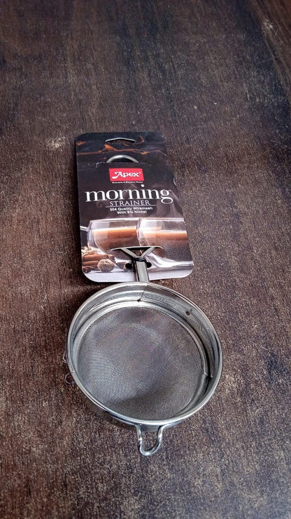 Stainless steel tea strainer positioned within a kitchen setting