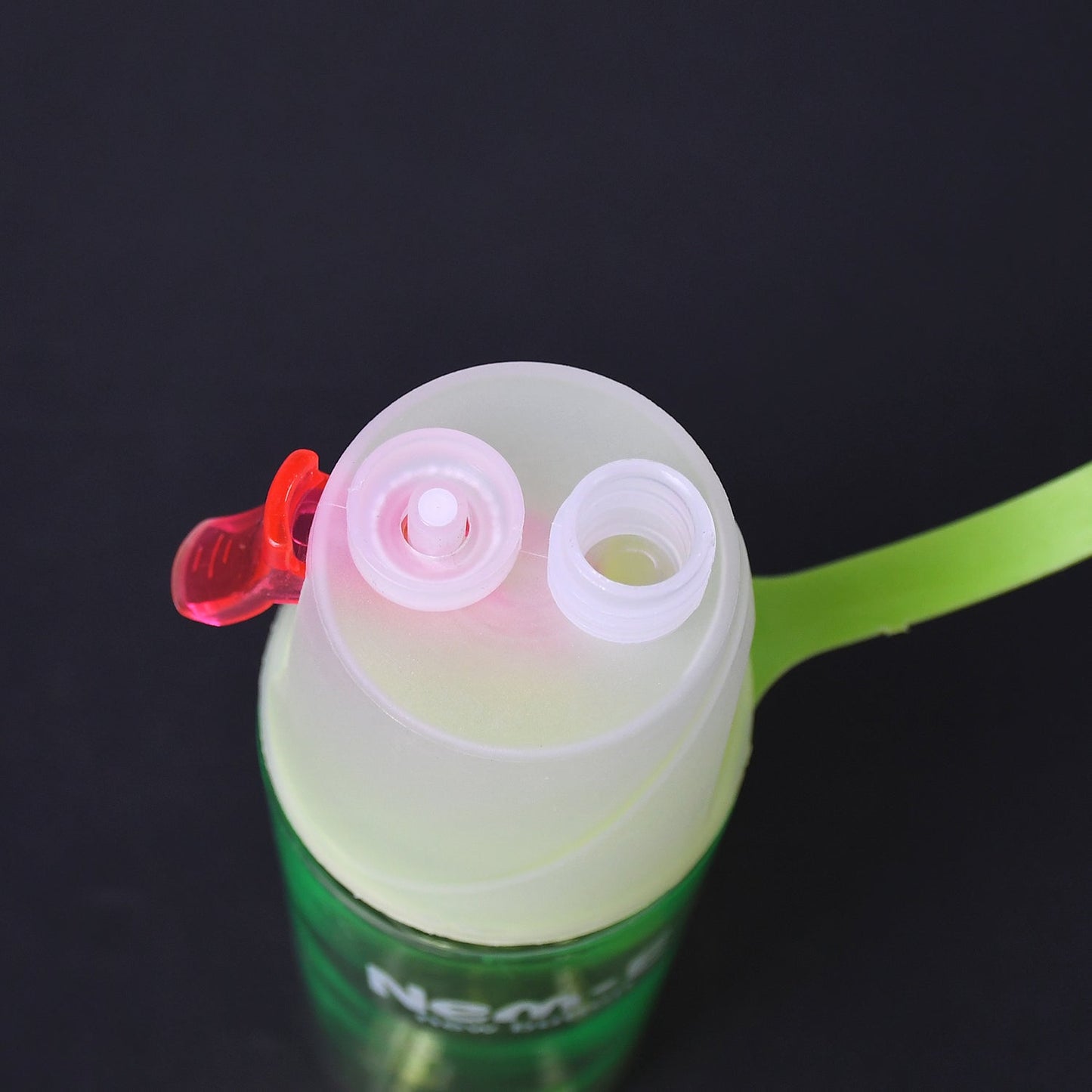 A durable sports spray water bottle used on a hiking trail, providing hydration and cooling mist.