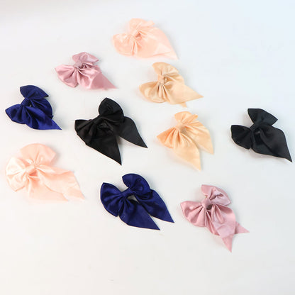 Variety of colorful satin bow hair clips for versatile styling