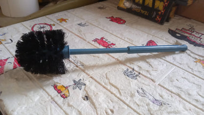 Plastic toilet cleaning brush with a strong handle for tough stains.