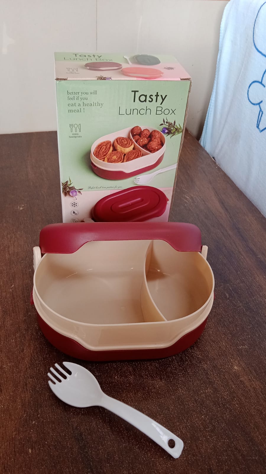 Compact airtight tiffin box with spoon, ideal for travel.