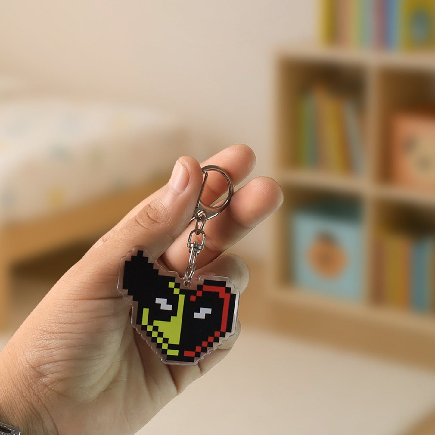 Backside of pixel style acrylic keychain showing sturdy metal lobster clasp