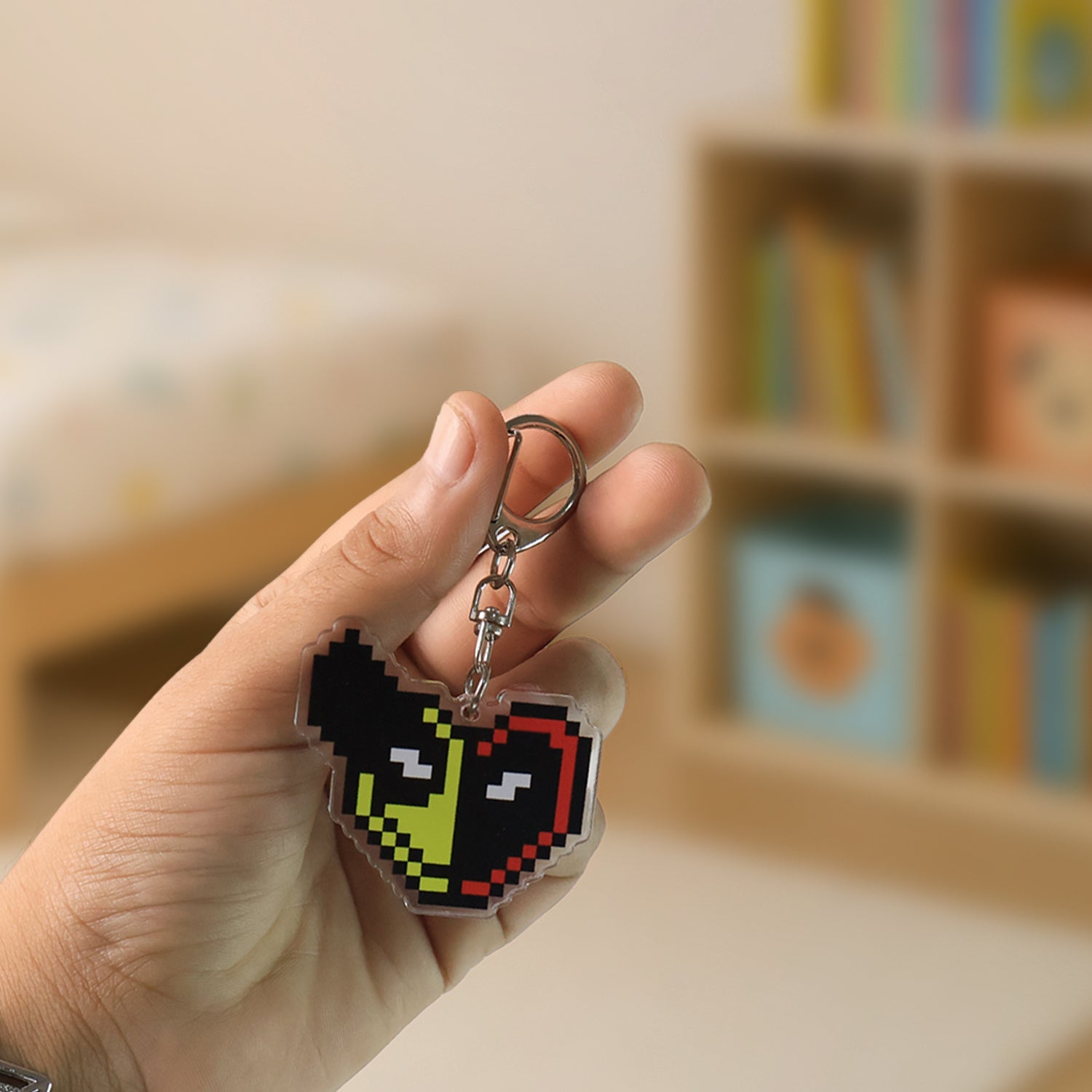 Backside of pixel style acrylic keychain showing sturdy metal lobster clasp